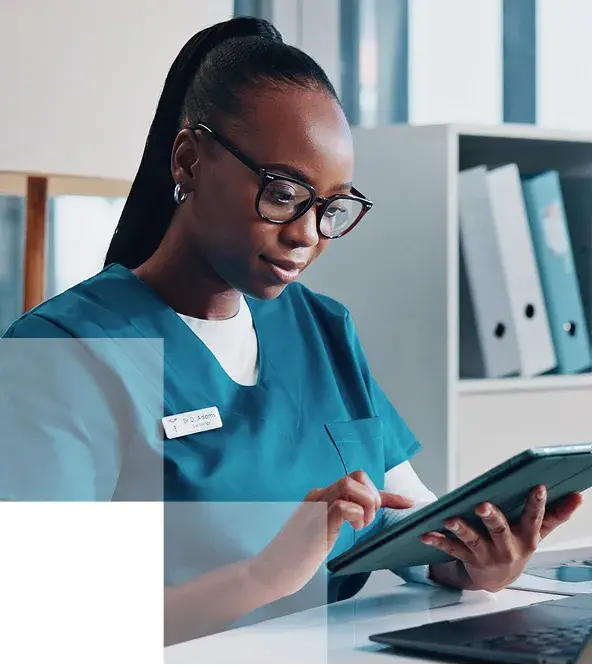image of a young woman working in a doctor'soffice checking a tablet